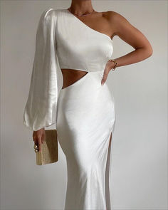 a woman wearing a white dress with one shoulder cut out and a slited skirt