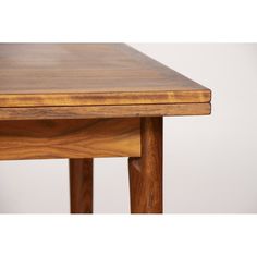 a wooden table with two legs and a small drawer on the top, against a white background