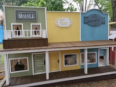 a doll house made to look like it is in the shape of a cafe with windows and doors