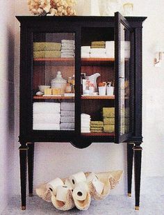 a cabinet with towels and other items in it