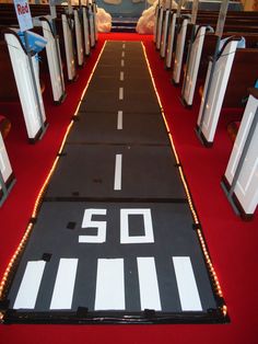 an aisle decorated with white and black lights for the 50th anniversary celebration to celebrate someone's 90th birthday