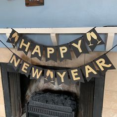 a happy new year banner hanging over a fireplace