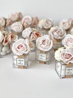 small glass vases filled with pink and white flowers