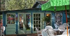 an outdoor cafe with tables and chairs outside