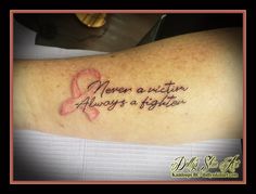 a woman with a pink ribbon on her arm that says, men are not always a fighter