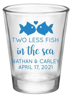 two less fish in the sea shot glass with blue lettering and hearts on the bottom