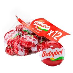 babybels are wrapped in red netting and sitting next to each other