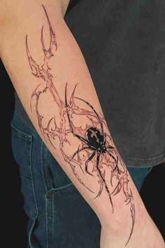 a person with a spider tattoo on their arm