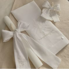 two white napkins with bows on them