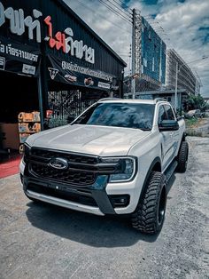 a white truck parked in front of a building