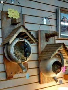 two bird houses are hanging on the wall