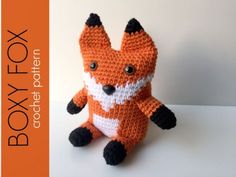 an orange and white crocheted fox sitting on top of a table with the words boxy lox written below it