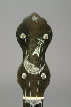 an old wooden guitar with some strings attached to it