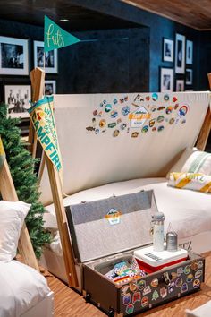 an open suitcase sitting on top of a wooden table next to a christmas tree and other decorations