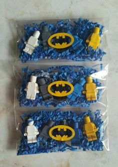 three lego batman figures are in plastic bags