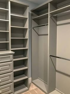 an empty walk in closet with shelves and drawers