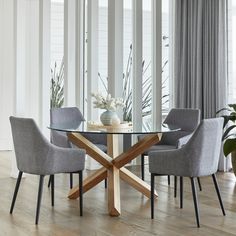 a glass table with four chairs around it