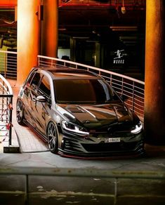 a black car parked in front of a building