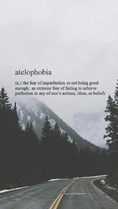 an empty road with trees on both sides and the words atelophobia above it