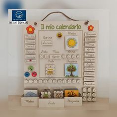 a wooden calendar with pictures and magnets on it