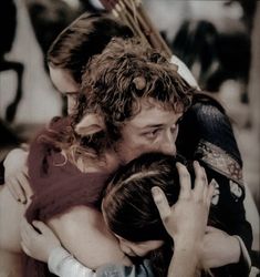 a group of people hugging each other