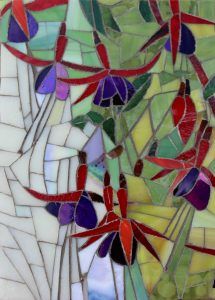 a stained glass window with red, purple and green flowers on it's side