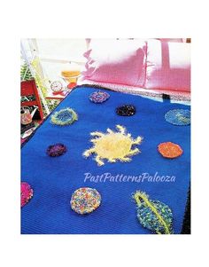 there is a blue crocheted bedspread with buttons on it