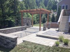 an outdoor patio with stone walls and steps