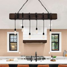 a kitchen with an island and several lights hanging from the ceiling