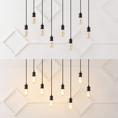 several light bulbs hanging from the ceiling in different styles and sizes, with one being turned on