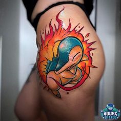 a woman's thigh with a tattoo design on her stomach and an image of a cartoon character in flames