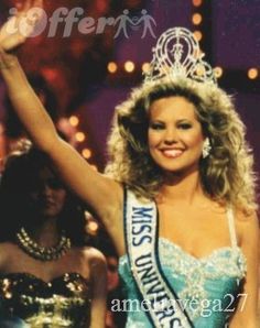 a woman in a blue and white dress with a crown on her head is standing next to another woman wearing a tiara