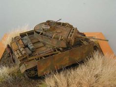 an old rusted tank sitting on top of dry grass