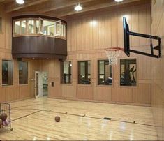 an indoor gym with basketball hoop and exercise equipment