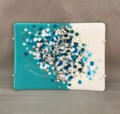 a blue and white glass plate with confetti sprinkles on it