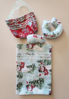 three pieces of cloth with christmas decorations on them and one piece of fabric tied to it