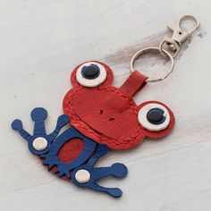 a red and blue frog keychain with eyes