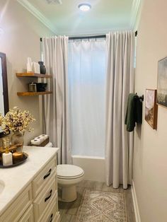 a bathroom with a sink, toilet and bathtub next to a window in it