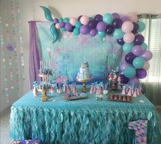 a table topped with lots of balloons and cake