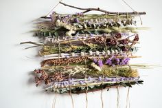 dried flowers and twigs hang on a wall