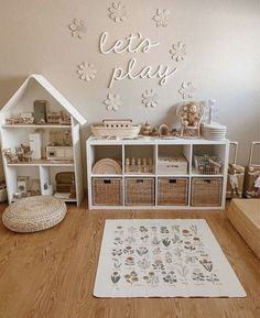 a playroom with toys, bookshelves and baskets on top of the floor