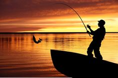 a man standing on top of a boat while holding a fishing rod in his hand