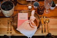 a place setting with napkins, silverware and candles