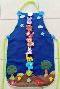 a child's apron made out of felt with teddy bears on it and stars