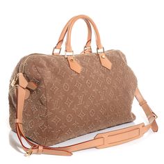 This is an authentic LOUIS VUITTON Denim Monogram Stone Speedy 35 in Caramel. This stylish tote is crafted of Louis Vuitton mini monogram fine beige denim. The bag features vachetta cowhide rolled leather top handles with brass links, a removable vachetta leather shoulder strap, and a top zipper with a padlock and a clochette with a key. The top zipper opens to a beige fabric interior with patch pockets. This is a marvelous tote, ideal for everyday use, from Louis Vuitton! Louis Vuitton Denim, Louis Vuitton Mini, Speedy Bandouliere, Speedy 35, Vintage Bag, Beige Fabric, Louis Vuitton Speedy Bag, Vintage Bags, Leather Top