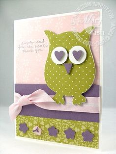 an owl is sitting on top of a card with pink and green trimmings