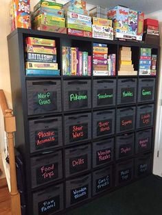 a black shelf filled with lots of toys and games