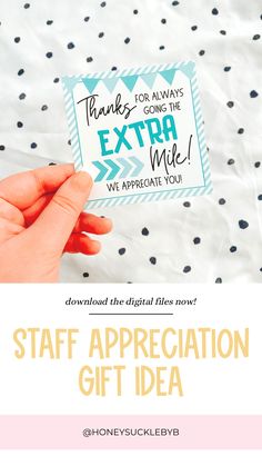 a hand holding a gift card that says, thank you for going the extra mile