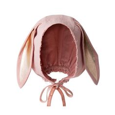 a pink bunny hat with ears tied to it