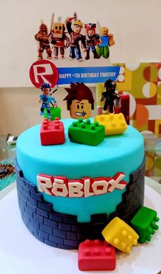 a birthday cake decorated with legos and toys